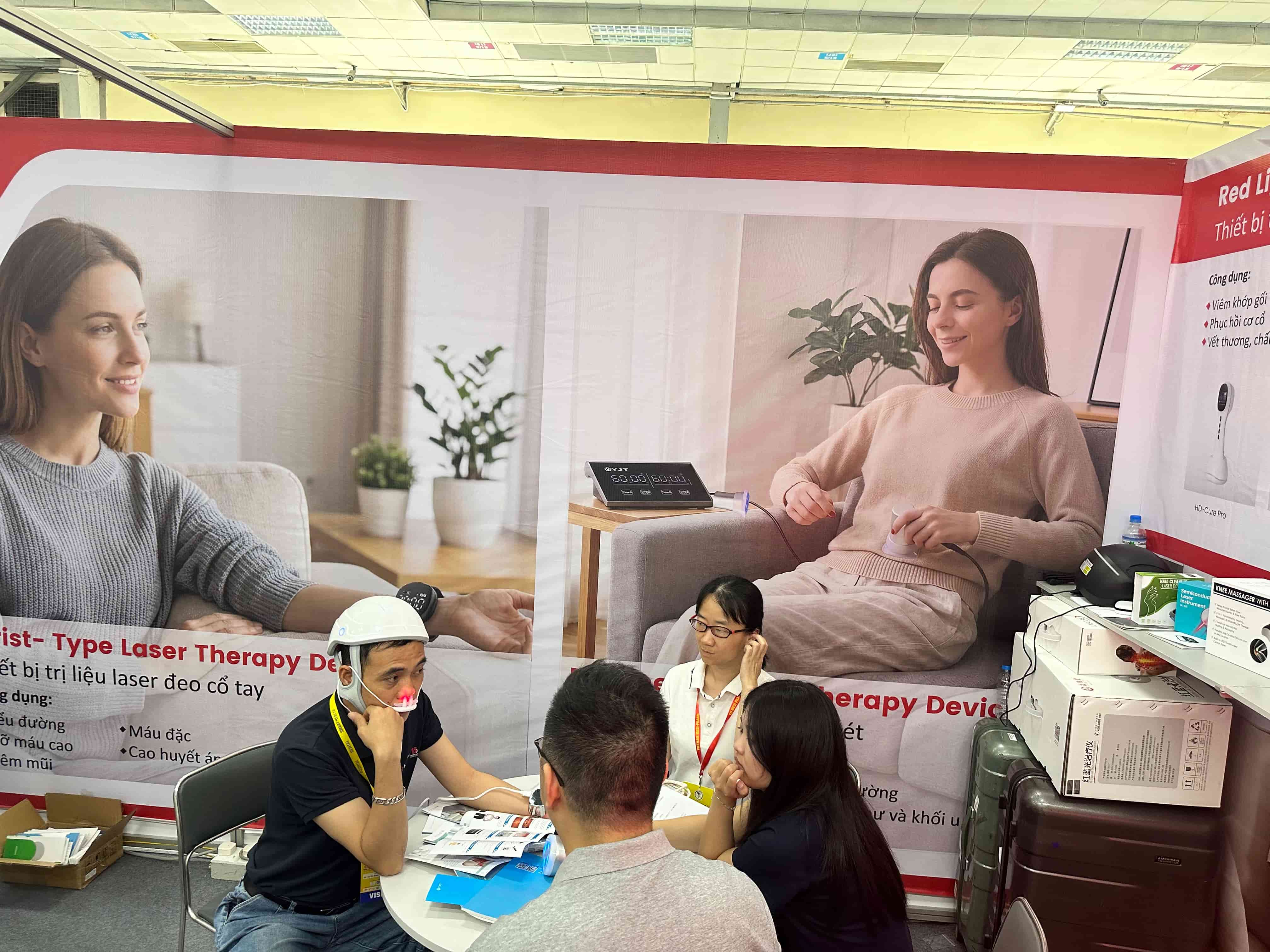 YJT Medical team explaining products to visitors