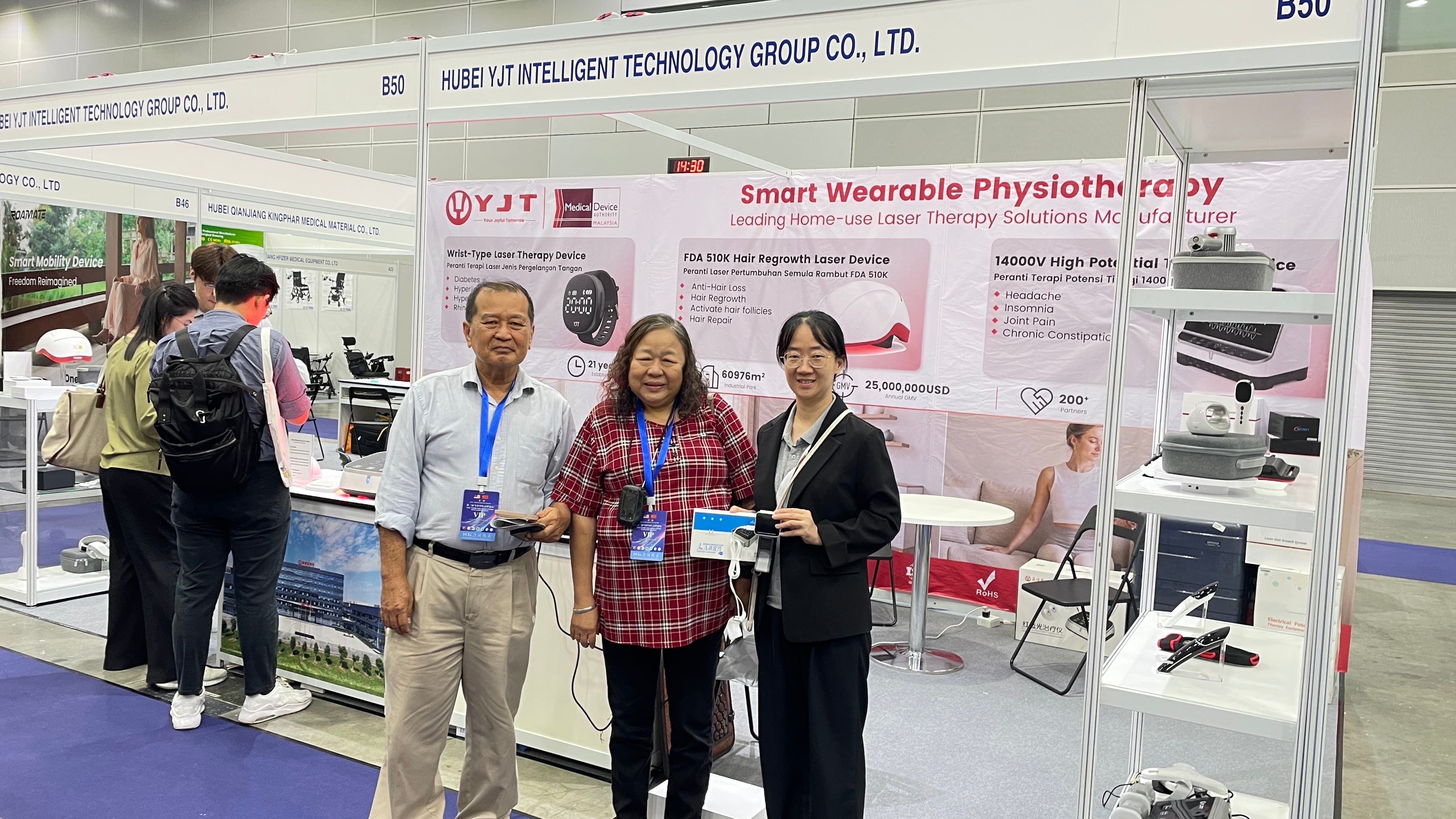 Visitors viewing YJT Medical laser therapy and rehabilitation devices at tHIS ASEAN 2026